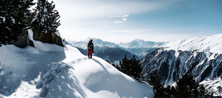 man standing on snowy mountain in winter